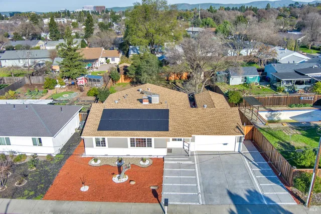 an aerial view of a house with a swimming pool