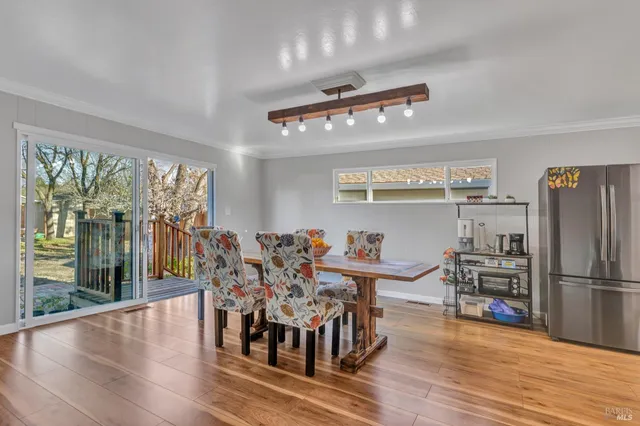 a view of a dining room with furniture large windows and wooden floor