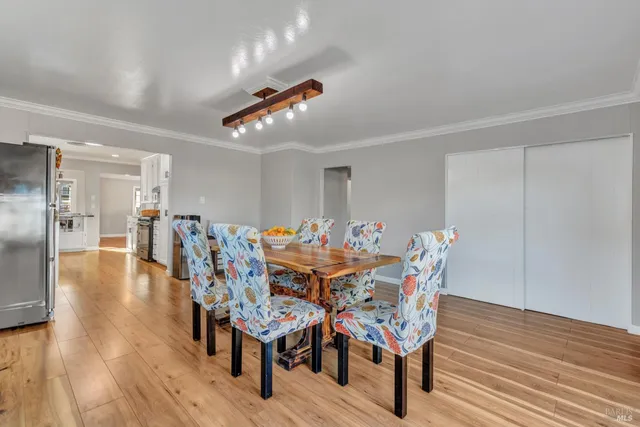 a view of a dining room with furniture and wooden floor