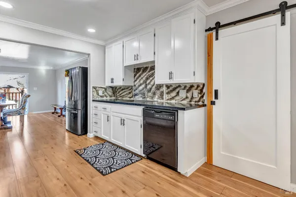 a kitchen with stainless steel appliances granite countertop a stove and a refrigerator