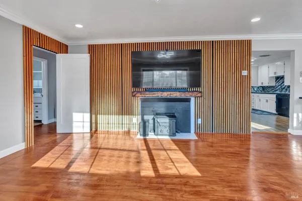 a view of livingroom with kitchen and fireplace