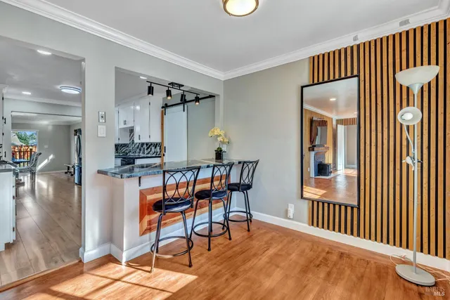 a view of a livingroom with furniture and hardwood floor