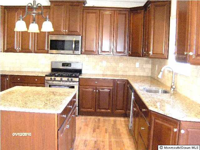 1203 Dorsett Dock Road Point Pleasant, NJ 08742 - Photo 3 of 3 a kitchen with a sink a microwave and cabinets