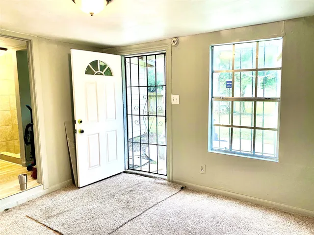 a view of an empty room with a window
