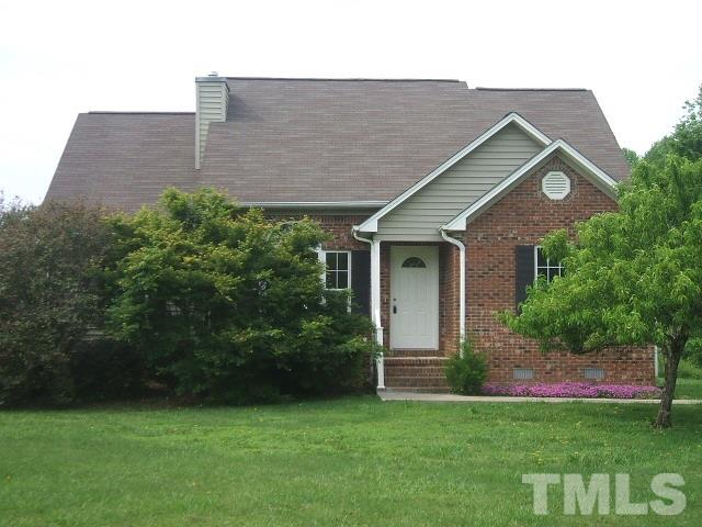 1094 Willie Gray Road Timberlake, NC 27583 - Photo 1 of 15 a front view of a house with a garden