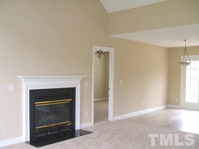 1094 Willie Gray Road Timberlake, NC 27583 - Photo 14 of 15 a view of an empty room with a fireplace and a window