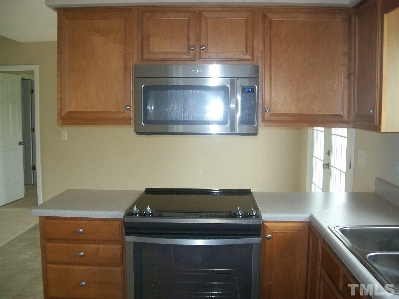 1094 Willie Gray Road Timberlake, NC 27583 - Photo 5 of 15 a stove top oven sitting inside of a kitchen