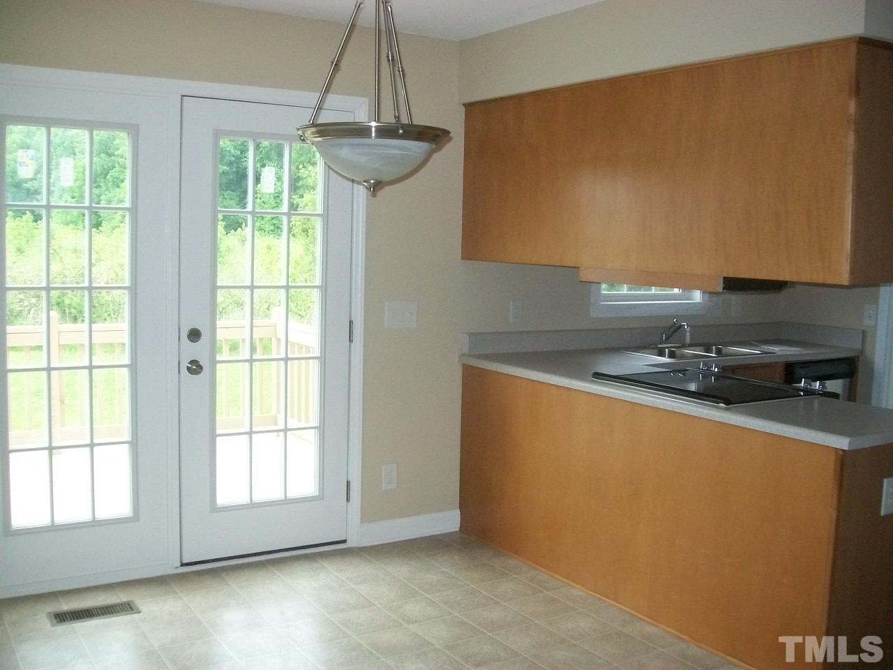 1094 Willie Gray Road Timberlake, NC 27583 - Photo 7 of 15 a kitchen with stainless steel appliances granite countertop a sink a stove and a granite counter top