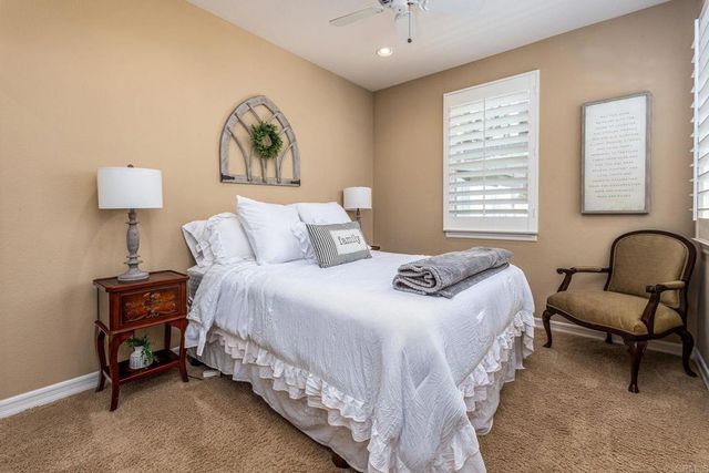 a bedroom with a bed and a lamp