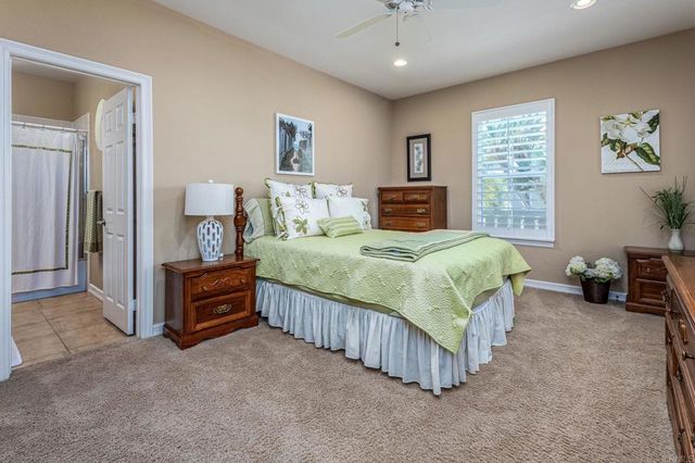 a bedroom with a bed and a tv