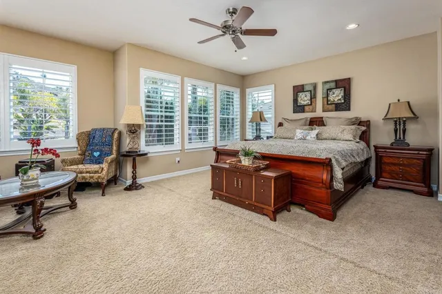 a spacious bedroom with a bed and a chandelier