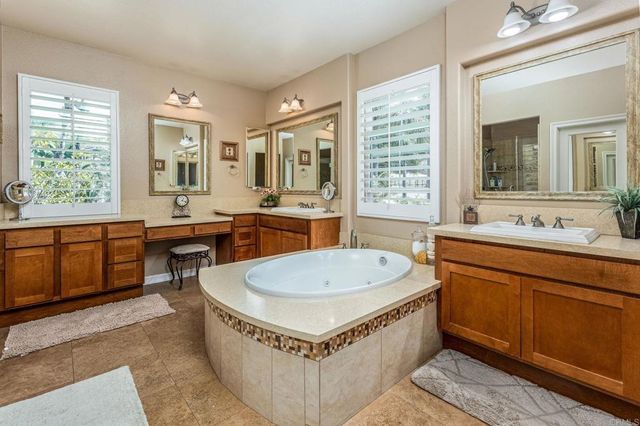 a living room with stainless steel appliances granite countertop a sink a counter space and a window