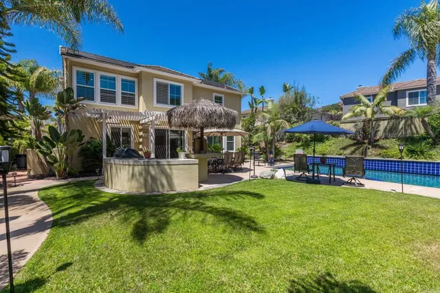 a view of a house with swimming pool and sitting area