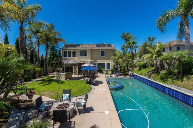 a view of a backyard with plants and a patio