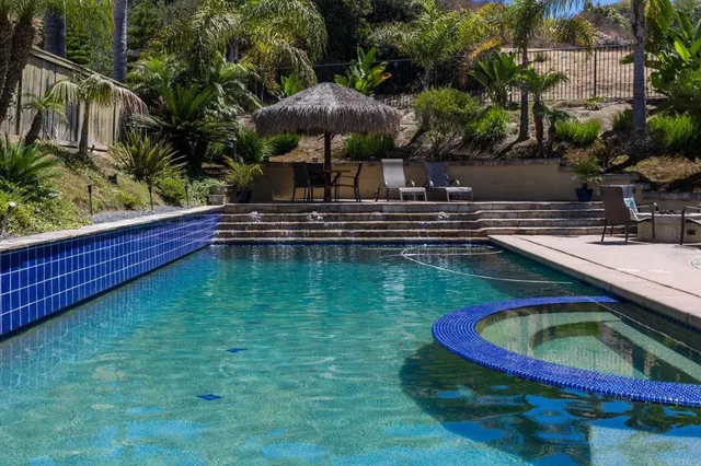 a swimming pool with outdoor seating and yard