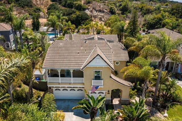 a view of a house with balcony and garden