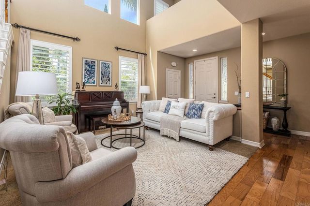 a living room with furniture and a lamp