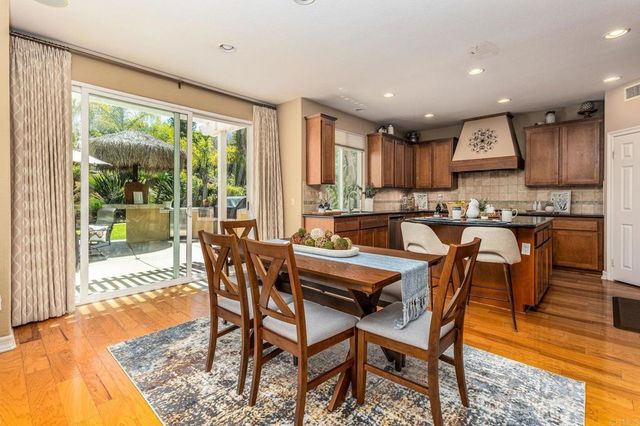 a dining room with furniture and wooden floor