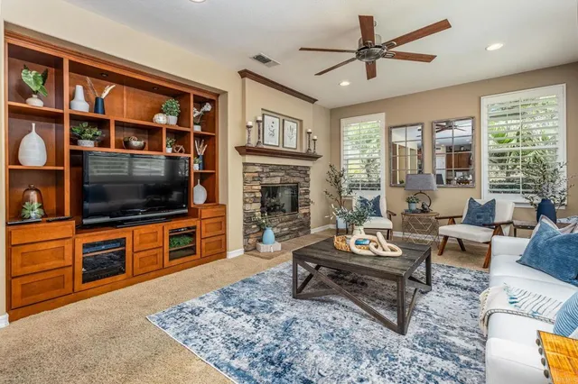 a living room with furniture a flat screen tv and a rug