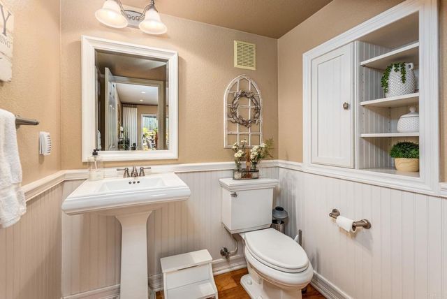 a bathroom with a toilet a sink and mirror