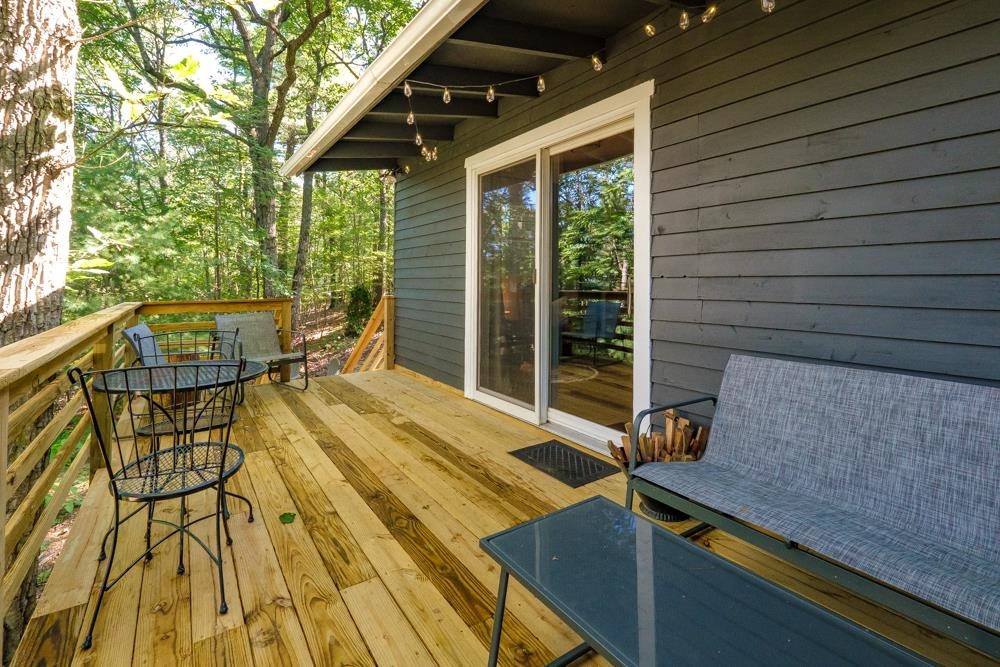 2781 Supinlick Ridge Road Mount Jackson, VA 22842 - Photo 23 of 28 a view of a patio with table and chairs with wooden floor and fence