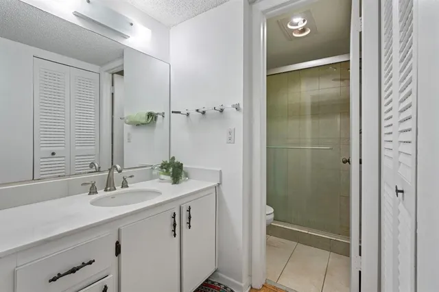 a bathroom with a sink and mirror with toilet