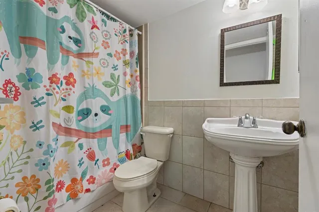 a view of a swimming pool with a bench and trees around