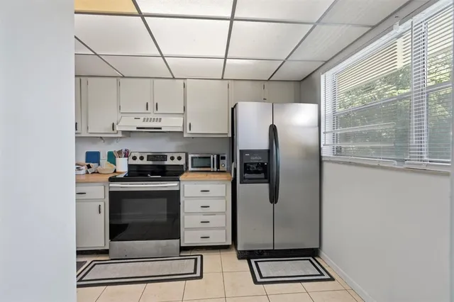 a bathroom with a window sink and mirror
