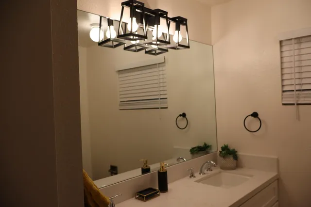 a bathroom with a sink and mirror