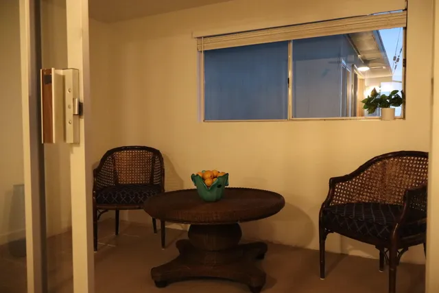 a view of a hallway and a bathroom with a sink