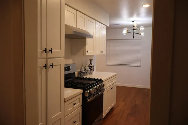 a kitchen with stainless steel appliances a refrigerator and a stove top oven