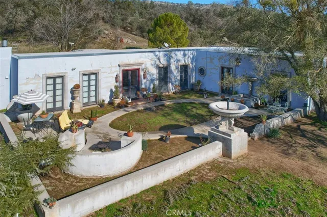 an aerial view of a house with swimming pool garden and patio