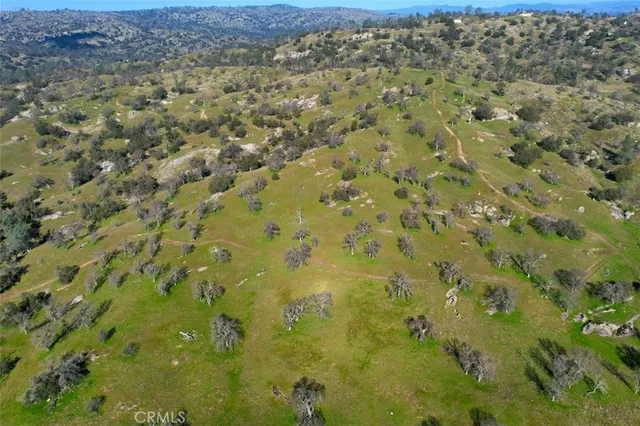 an aerial view of house with yard and outdoor seating