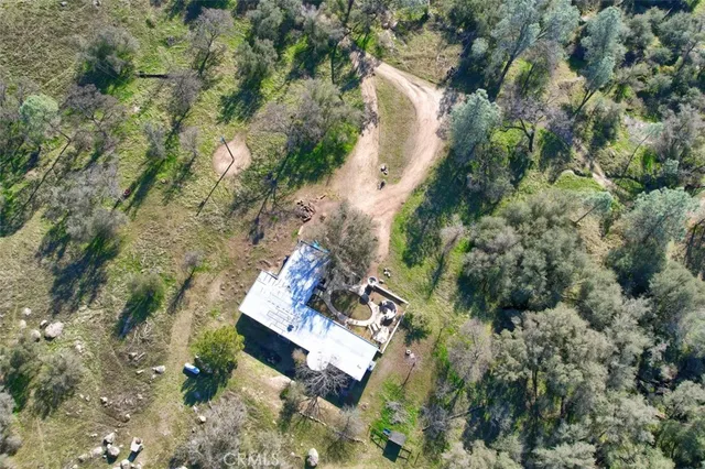 an aerial view of a house with a yard and lake view