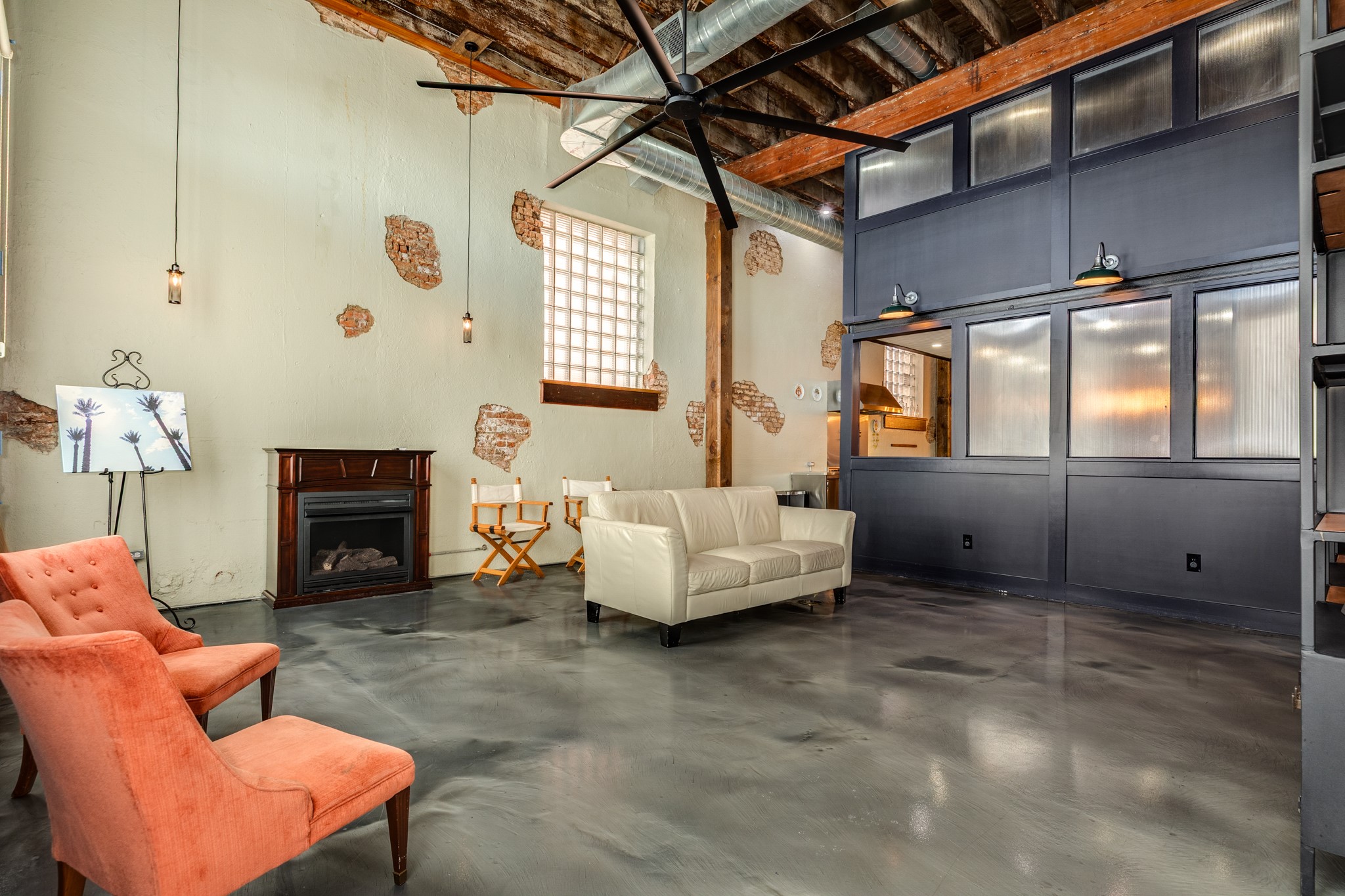 214 Rosenberg Street, Unit 214 Galveston, TX 77550 - Photo 15 of 41 a living room with furniture a fireplace and a large window