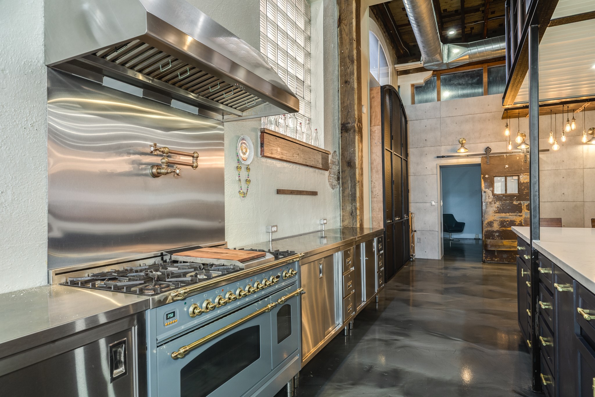 214 Rosenberg Street, Unit 214 Galveston, TX 77550 - Photo 23 of 41 a kitchen with stainless steel appliances granite countertop a stove and a refrigerator