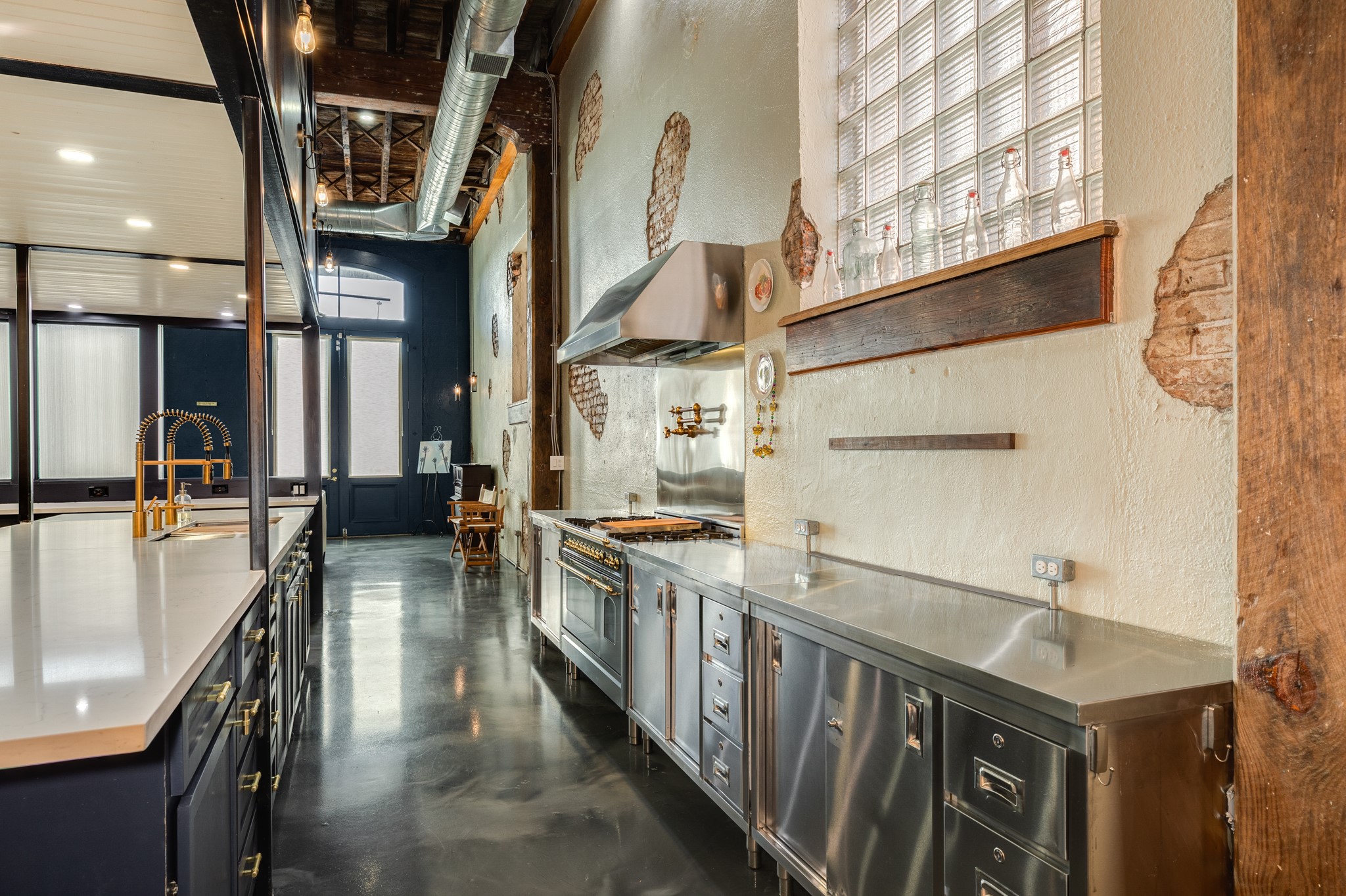 214 Rosenberg Street, Unit 214 Galveston, TX 77550 - Photo 24 of 41 a kitchen with stainless steel appliances granite countertop a sink a stove and a wooden floors