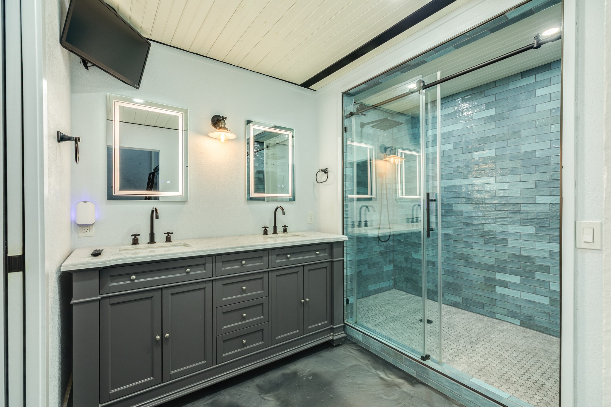 214 Rosenberg Street, Unit 214 Galveston, TX 77550 - Photo 33 of 41 a bathroom with a shower sink and mirror