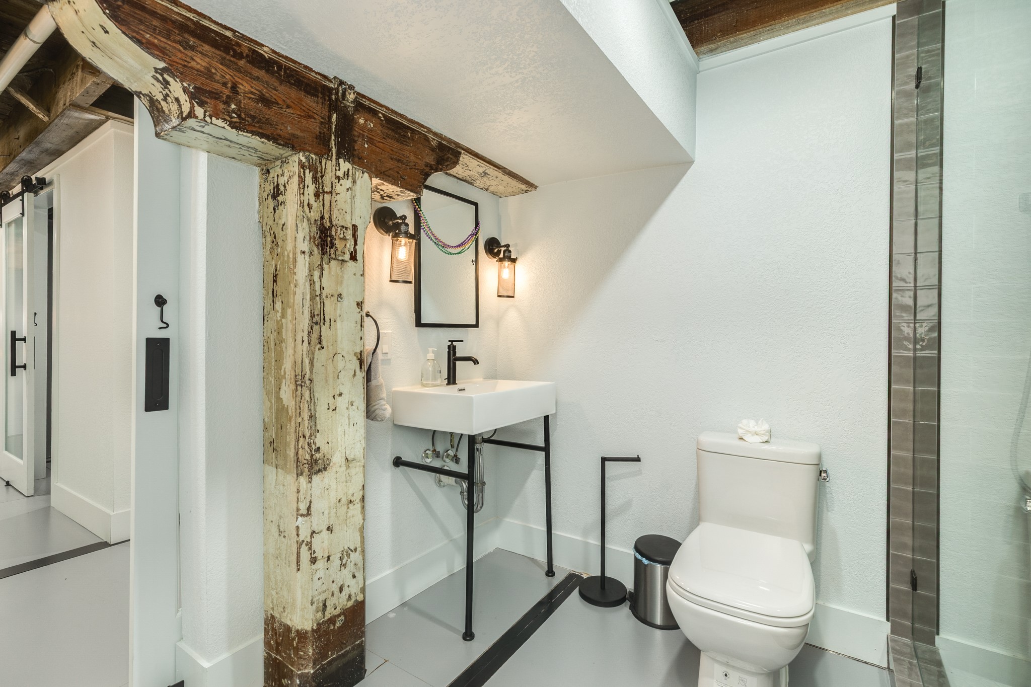 214 Rosenberg Street, Unit 214 Galveston, TX 77550 - Photo 40 of 41 a bathroom with a toilet a sink and shower