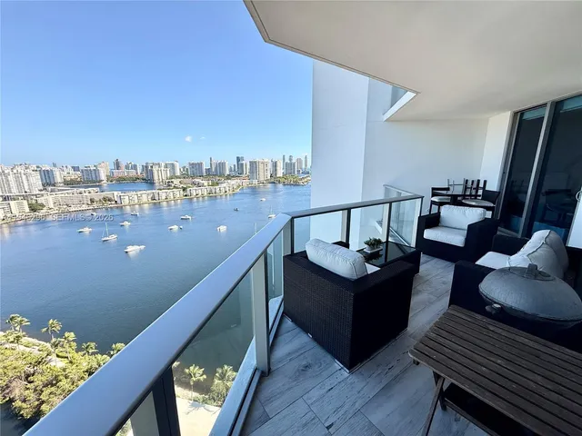 a view of a balcony with wooden chairs
