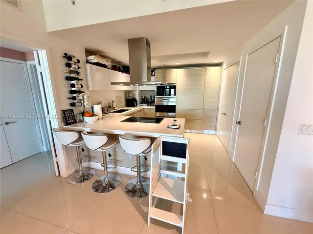 a dining room with furniture and a floor to ceiling window