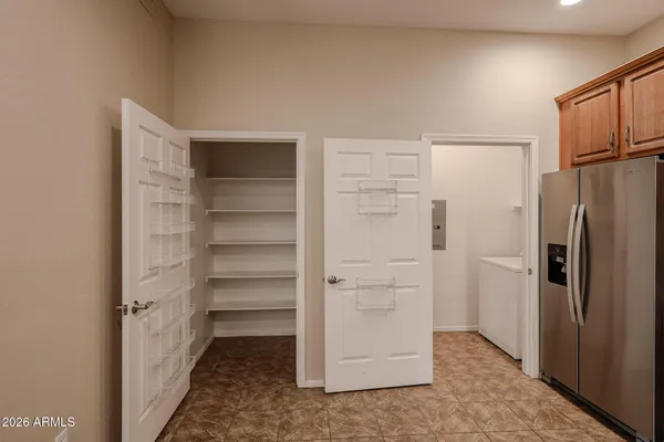 a kitchen with stainless steel appliances granite countertop a refrigerator a stove a sink and a refrigerator