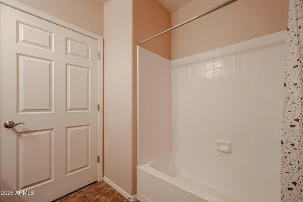 an empty room with closet and ceiling fan