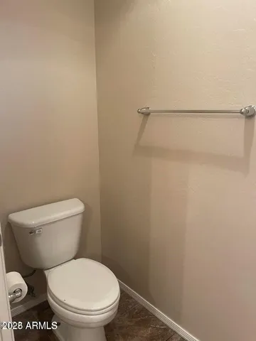 a white toilet sitting next to a shower