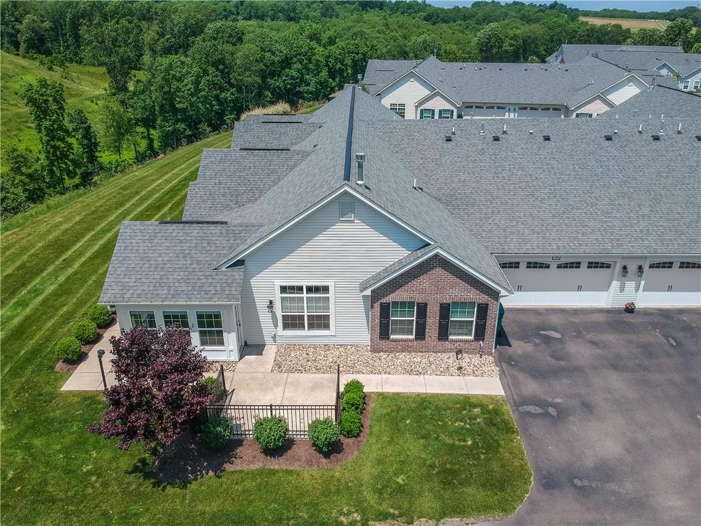 a view of house with garden and a sitting area