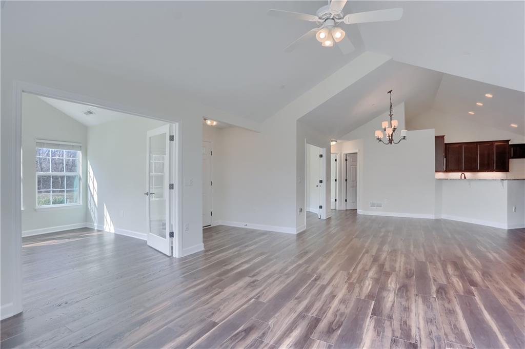 705 Spring Valley Drive Zelienople, PA 16063 - Photo 18 of 34 a view of a livingroom with wooden floor and a ceiling fan