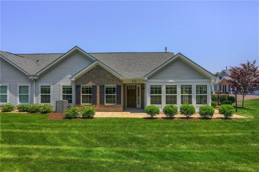 705 Spring Valley Drive Zelienople, PA 16063 - Photo 2 of 34 a front view of a house with a garden and plants