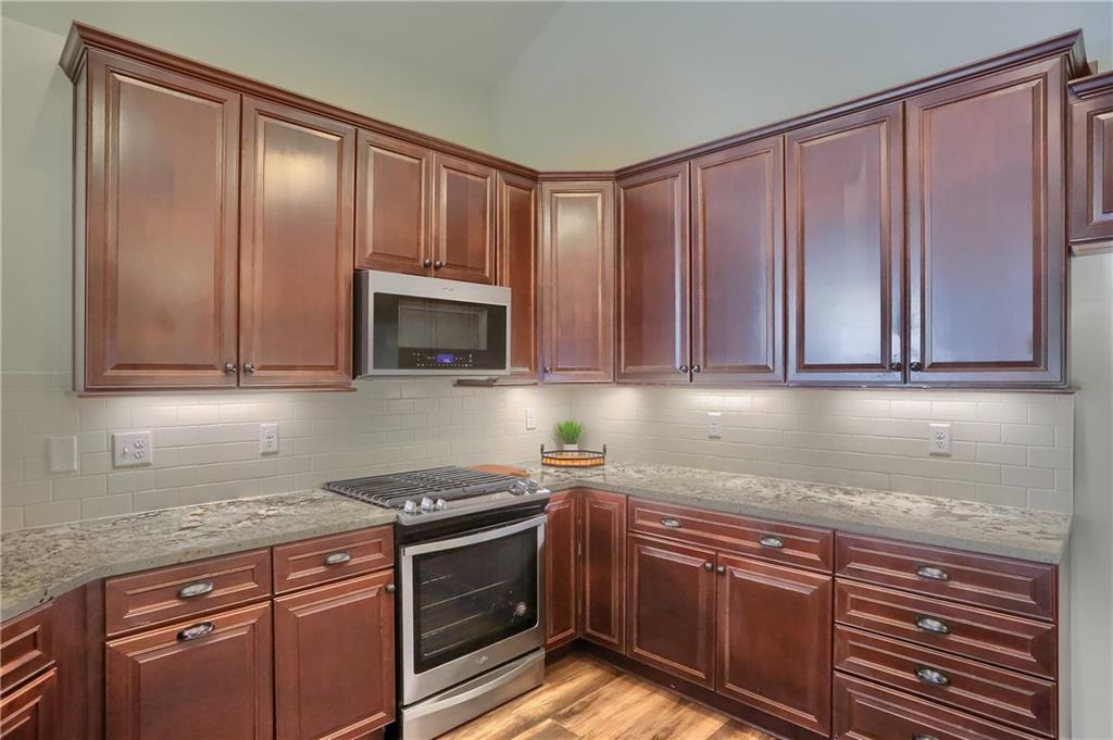 705 Spring Valley Drive Zelienople, PA 16063 - Photo 21 of 34 a kitchen with granite countertop stainless steel appliances wooden cabinets and a counter top space