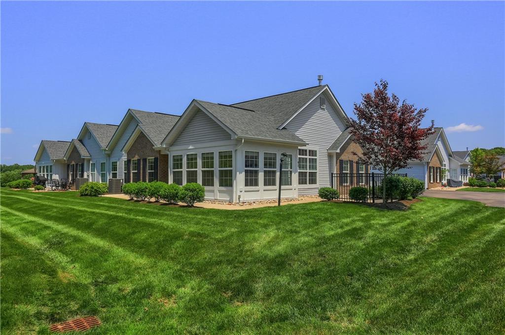 705 Spring Valley Drive Zelienople, PA 16063 - Photo 32 of 34 a front view of a house with a garden and porch