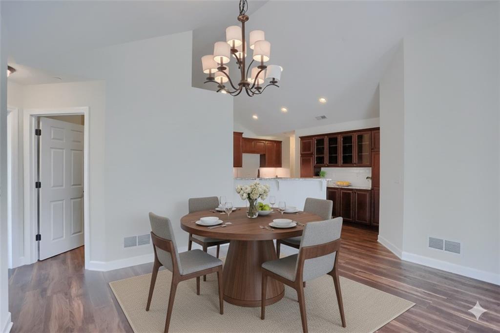 705 Spring Valley Drive Zelienople, PA 16063 - Photo 5 of 34 a view of a dining room with furniture wooden floor and a chandelier